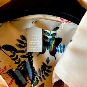 H&M shirt, polyester, owned. Butterfly print. Predominately colour beige.